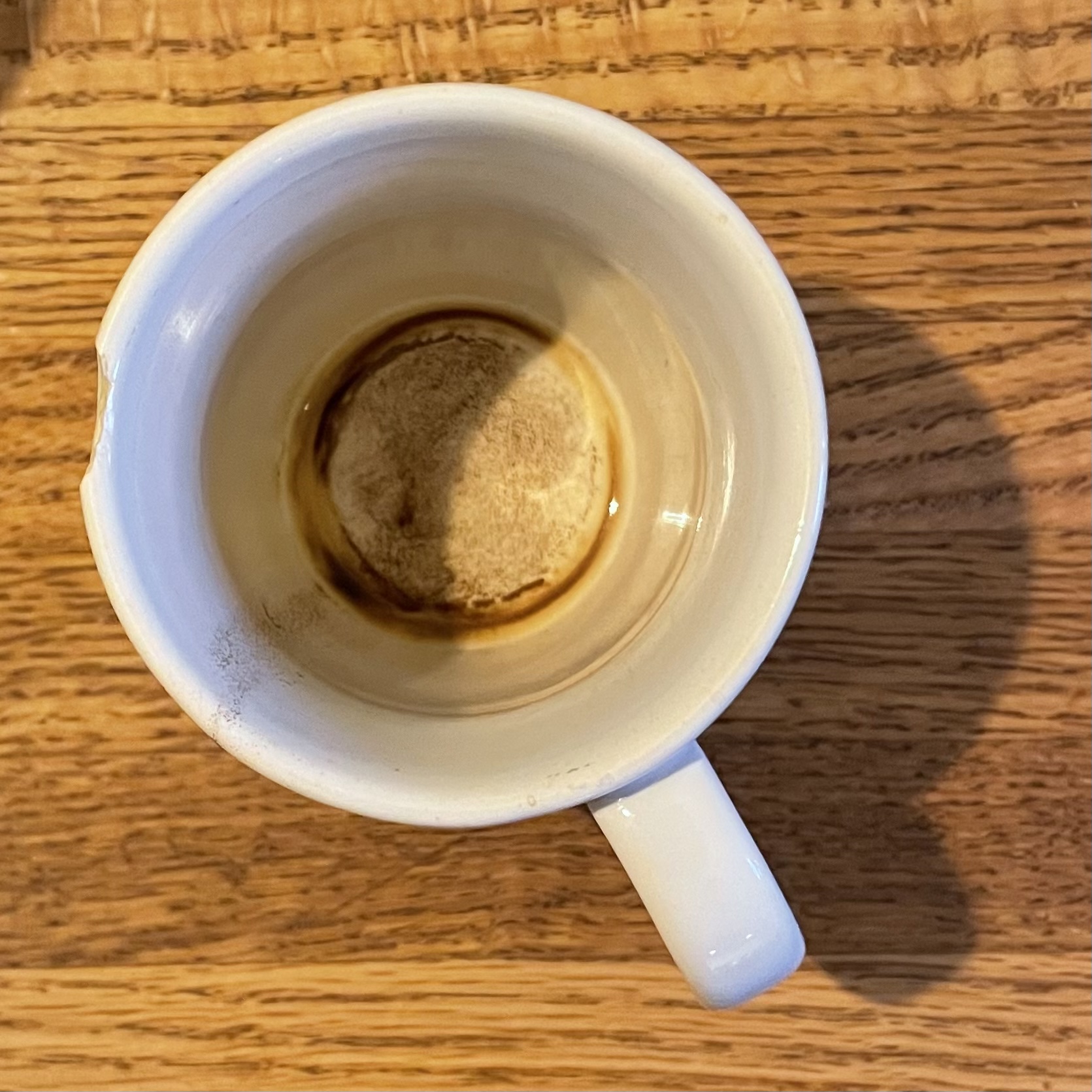 a chipped mug now empty of coffee
