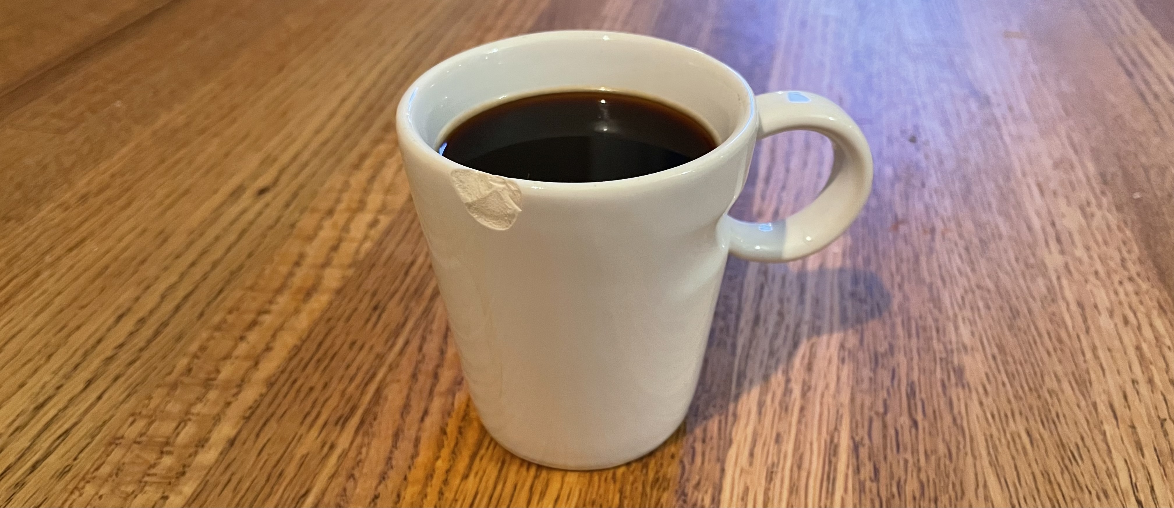 A chipped cup of coffee